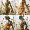 作品采用玻璃材质描绘身穿花裙的女性轮廓，以鲜花为材料，富士长青500吨，户外艺术，柔和梦幻的氛围，花朵的力量，大大小小的春花五彩缤纷，有节奏感，红、白、黄，流行灵感--风格化250--AR 3：4