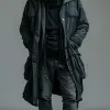 照片，正视图，全身拍摄，专业模特，男性，金发Undercut发型，站在纯灰色背景上，凝视相机，额头有皱纹，由Richard Avedon风格，使用的相机是索尼阿尔法9 II，配备索尼FE 100- 400 mm f/4.5-5.6 GM OSS镜头，穿着黑色长袖羊毛衫搭配哑光黑色连帽衫，深灰色货物慢跑裤，Nike Killshot运动鞋和白色鞋带，逼真的摄影，高对比度--ar 9：16 --sty
