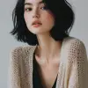 时尚杂志摄影，黑发模特女模特坐在镜头前，穿着轻薄优雅的秋冬系列，敞开毛衣搭配连衣裙衬衫，Canon EOS-1D，f/5.6，扎实轻盈的背景，衬托工作室灯光--ar 9：16