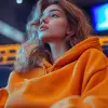 photography, vast emptiness of a movie theater serves as the backdrop for a moment of carefree repose, woman lounges across the seats, a picture of relaxed ease in an oversized orange color hoody and 