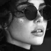 a woman wearing black sunglasses and a hat, in the style of black and white imagery, vray tracing, tamron sp 70-200mm f/2.8 di vc usd g2, bold fashion photography, luminous shadowing, close-up, crisp 