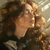 a woman with long hair laying in bed, in the style of yigal ozeri, anamorphic lens flare, bella kotak, video, close up, jagged edges, light beige and blue --ar 73:108 --stylize 750 --v 6