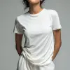 女时装模特站立，穿着纯白T恤和白色短裤，姿势休闲，双手在外面放松，中性灰色背景，全身，极简主义工作室灯光   --ar 9：16