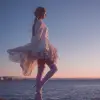 海边黄昏，少女穿白色飘逸长裙与浅粉色过膝丝袜，脚踩细跟鞋，白与粉色调，浪漫唯美风格，裙摆随海风飞扬，夕阳余晖映射腿部，氛围梦幻     --ar 3:4