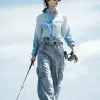 夏季湖畔垂钓，女士防晒长袖与速干裤，浅蓝与灰色调，清爽户外风格，长袖袖口与裤脚细节，湖面阳光反射衣物，服饰设计效果图     --ar 3:4